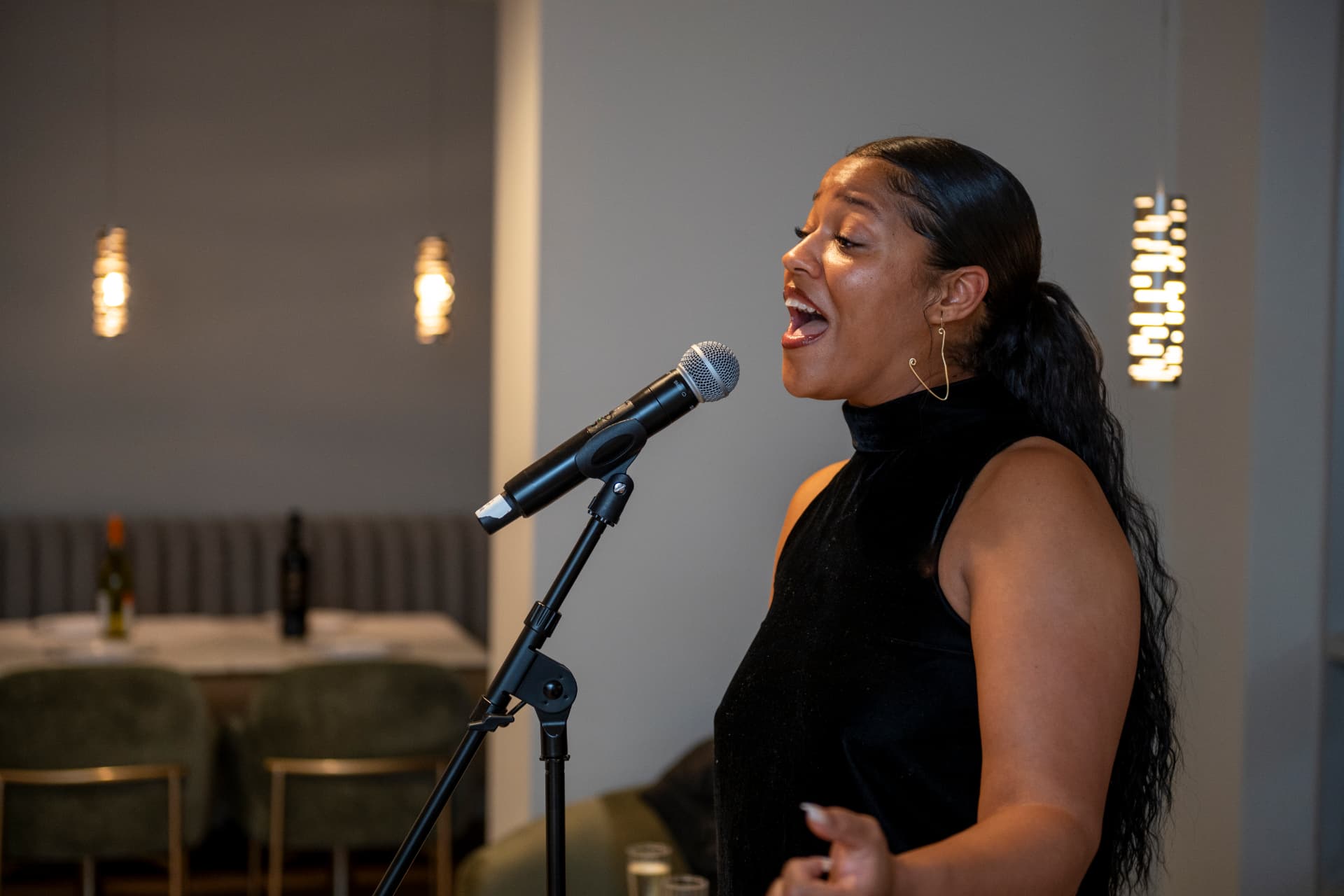 Ezeada singing in an intimate live setting