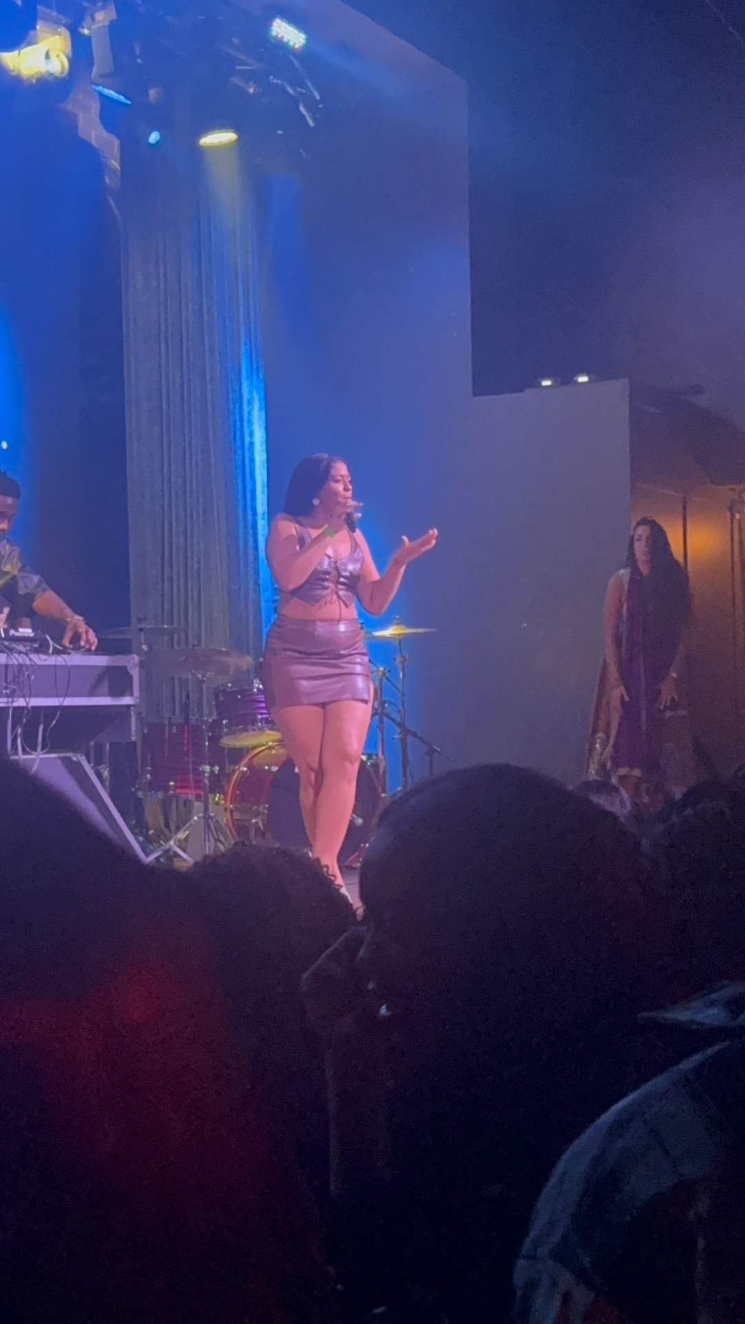 Ezeada performing on a blue-lit stage